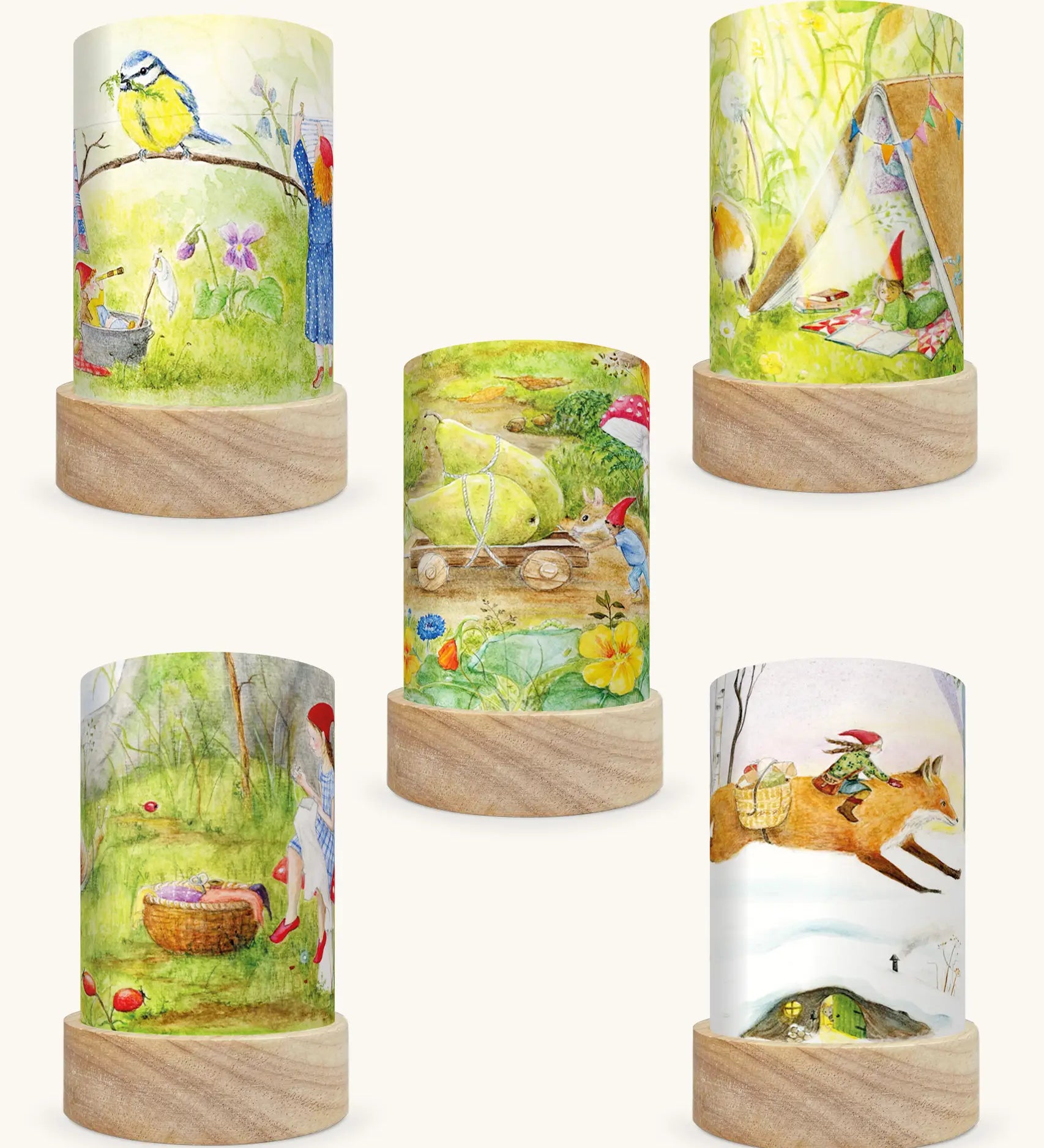 Set of 5 Toverlux Lantern Shades by Mhairi Hellbrandt pencil and paint artworks of gnome tales including 5 different seasonal illustrations on each. Spring gnomes with a blue tit,  Summer gnomes in a tent with a robin, September gnomes harvesting pears, Autumn gnomes mending clothes and Winter gnomes riding a fox in a snow covered forest.
