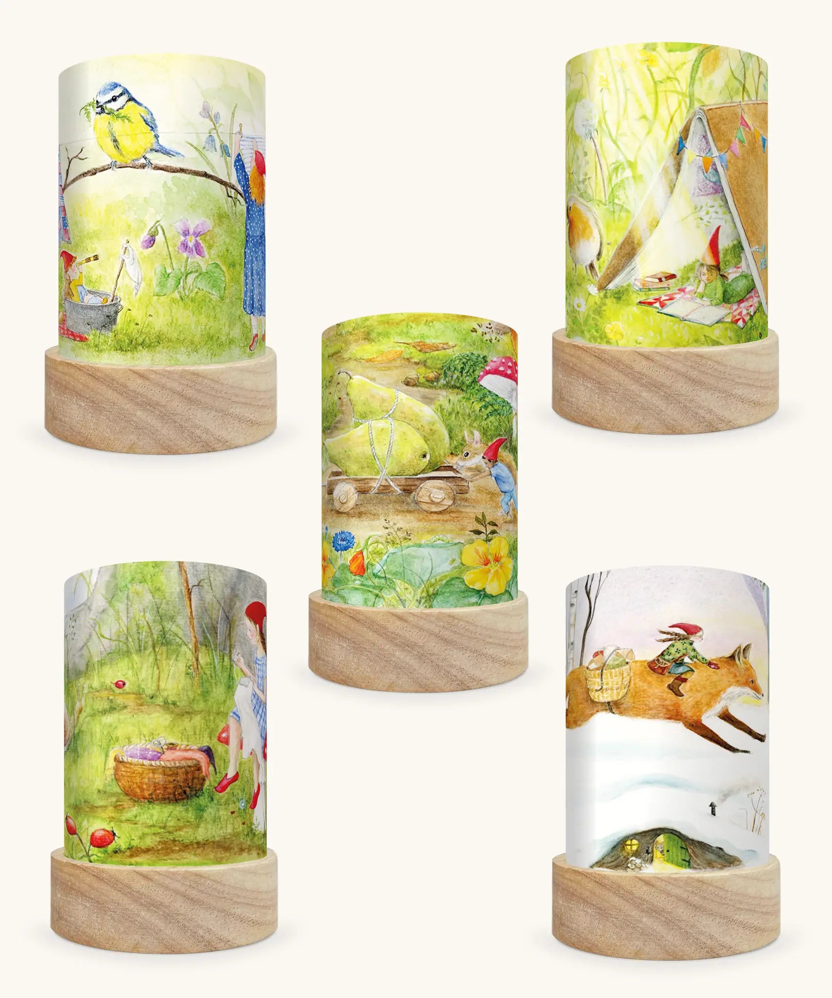 Set of 5 Toverlux Lantern Shades by Mhairi Hellbrandt pencil and paint artworks of gnome tales including 5 different seasonal illustrations on each. Spring gnomes with a blue tit,  Summer gnomes in a tent with a robin, September gnomes harvesting pears, Autumn gnomes mending clothes and Winter gnomes riding a fox in a snow covered forest.
