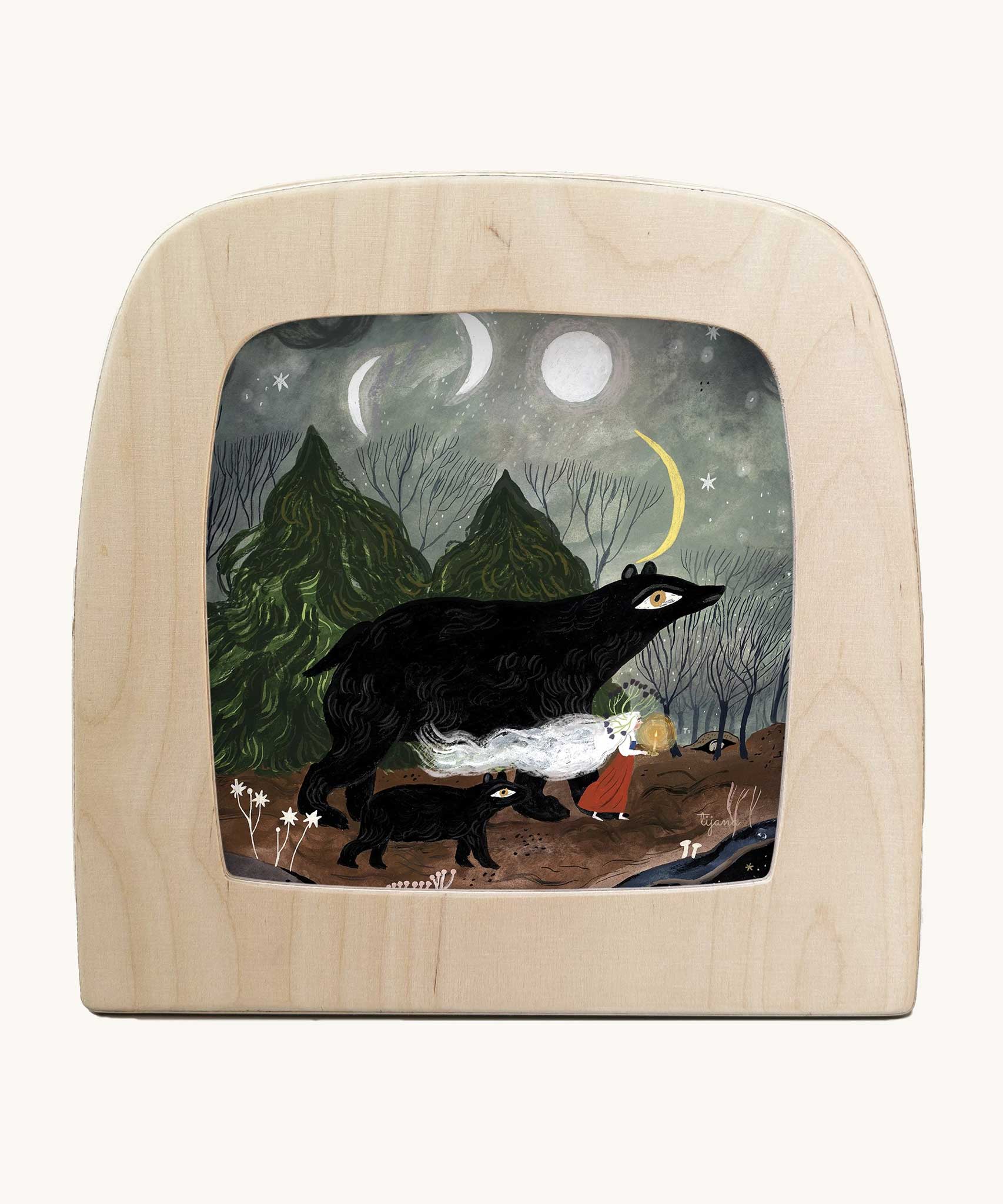 Toverlux Magic Lamp Silhouette Illustration Black Bears by Tijana Draws. The artwork features black bears walking through a forest accompanied by a lady with a lit candle. We have a range of Toverlux silhouettes, lamps and accessories available at Babipur.