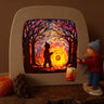 Toverlux DIY kit creation featuring a multicoloured sky with a silhouette of a child carrying a lantern through a forest in a parade displayed in a lit up magic lamp.