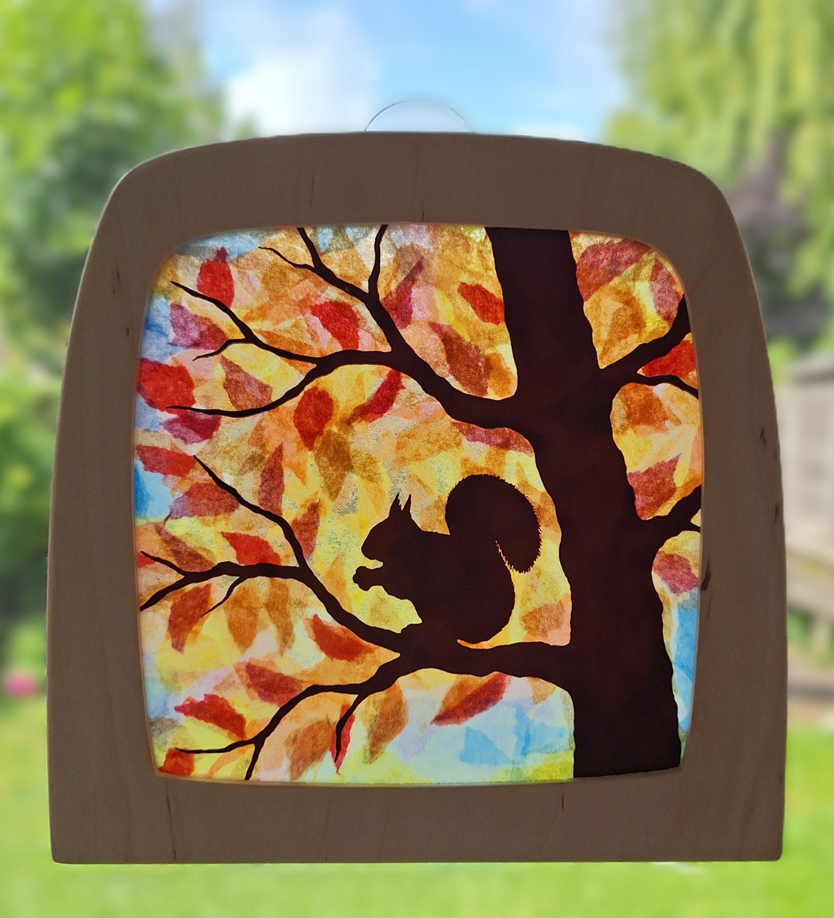 A Toverlux DIY Transparencies with  Autumn Squirrel artwork shown in a wooden magic window frame.