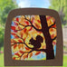 A Toverlux DIY Transparencies with  Autumn Squirrel artwork shown in a wooden magic window frame.