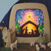 A Toverlux DIY Transparencies with  Winter nativity artwork shown in a wooden magic lamp. Ostheimer wooden toys have been placed in front of it.