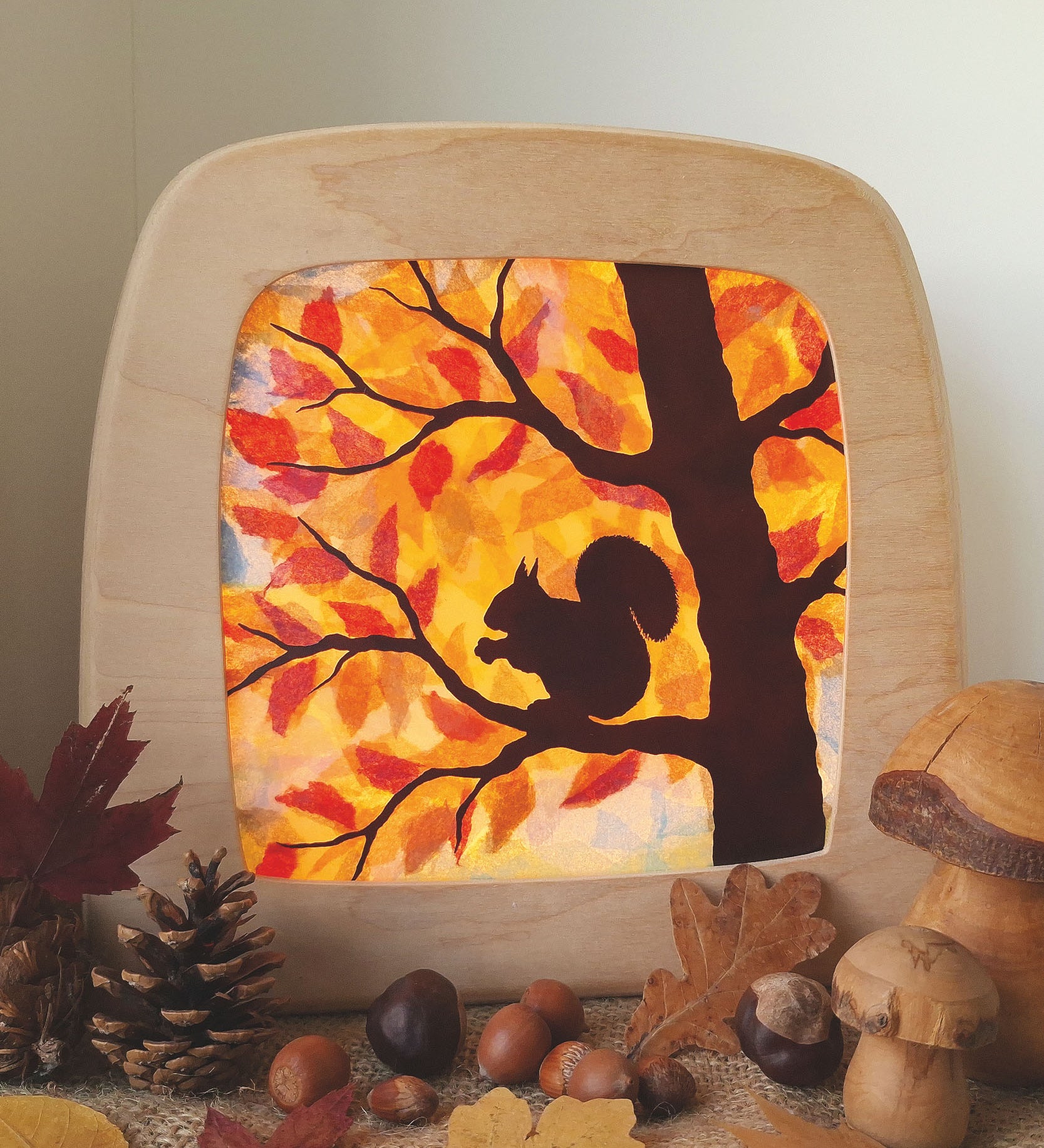 A Toverlux DIY Transparencies with  Autumn Squirrel artwork shown in a Toverlux wooden magic lamp.