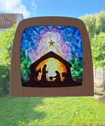 A Toverlux DIY Transparencies with  Winter nativity artwork shown in a wooden magic window frame.