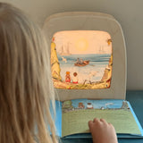 Child looking at Toverlux Edulux Water Cycles Set in the Toverlux Magic Lamp with information book by Stephanie Green Wilded Family.