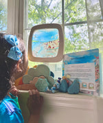 Toverlux Edulux watercycles silhouette featuring Stephanie Green's Estuary artwork shown in a wooden magic window frame. A Grimm's weather set has been set up on the windowsill underneath and a child is looking at the artwork.
This silhouette is part of a wide range of Toverlux silhouettes available here at Babipur. 