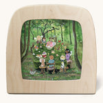 Toverlux Magic Lamp silhouette by artist Gwen van Knippenberg. A watercolour and pencil style illustration of fairy children having a tea party in a green forest.