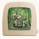 Toverlux Magic Lamp silhouette by artist Gwen van Knippenberg. A watercolour and pencil style illustration of fairy children having a tea party in a green forest.