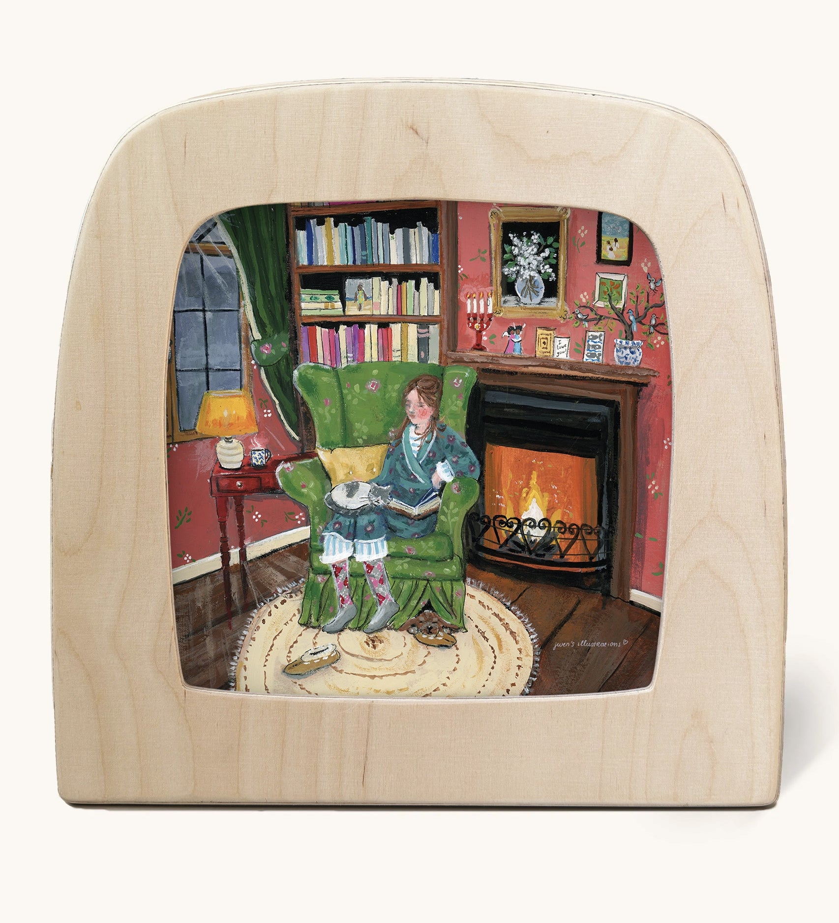Toverlux Magic Lamp silhouette by artist Gwen van Knippenberg. A watercolour and pencil style illustration of a woman ready on a cosy looking green sofa in front of a fireplace, with a grey and white cat sleeping on her lap.