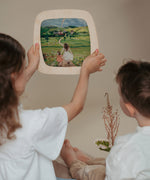 2 children looking at a silhouette inside a Toverlux Magic Window Frame available at Babipur. 