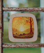 A close up of a Autumn woodland inspired Toverlux silhouette inside a 2 children looking at a silhouette inside a Toverlux Magic Window Frame available at Babipur. 