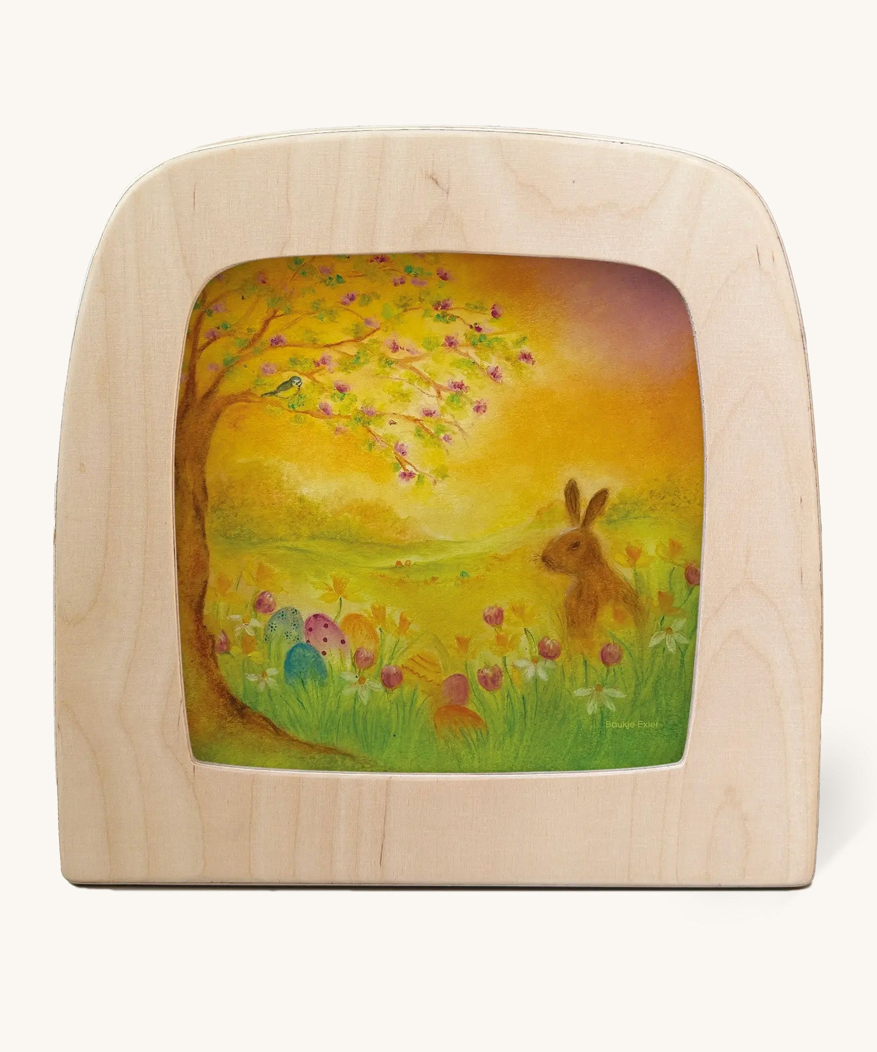 Egg hunt Toverlux Magic Lamp Silhouette - Artwork By Baukje Exler. A chalky style illustration of a rabbit in a field next to a tree with a sunset sky surrounded by easter eggs 
