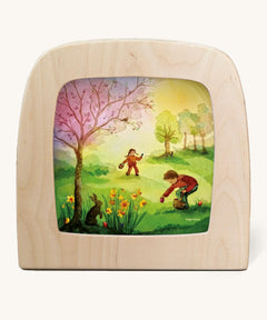 Toverlux magic lamp with a Easter discovery silhouette by artist Vogel Geluk. A watercolour style illustration of 2 children in a field looking for easter eggs.