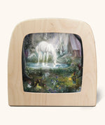 Toverlux silhouette artwork of a white unicorn drinking from a lake in a magical woodland scene with pixies, fairies, and toadstools.