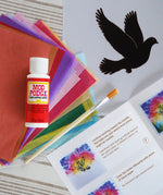Toverlux Spring dove DIY silhouette transparency craft kit featuring a Vogel Geluk design. The kit includes silhouette panel with dove design, 20 sheets of coloured paper, paint brush, mod podge glue sealer and a step by step instruction guide.