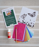 Contents of the Toverlux Summer butterflies DIY silhouette transparency craft kit featuring a Vogel Geluk design. The kit includes silhouette panel with dove design, 20 sheets of coloured paper, paint brush, mod podge glue sealer and a step by step instruction guide.