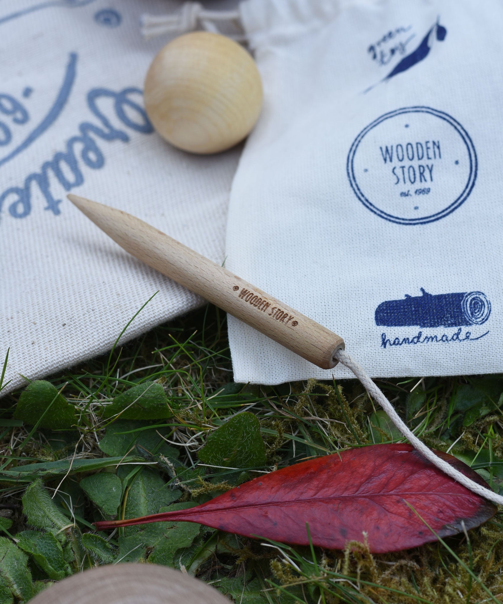 A close up of the wooden marker and string on the cotton storage bags. The smaller jack ball can be seen in the background. 