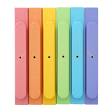 Triclimb wooden pastel miri sticks laid out in a line on a white background