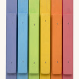Bottom view of the Triclimb wooden pastel Miri sticks showing the extended base where the stick can slot on top of the Triclimb Miri slide