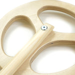 Close up of the Triclimb arben wooden steering wheel attachment on a white background