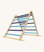 Triclimb folding wooden pikler climbing frame with light and dark blue rungs. Features a natural coloured rungs on the bottom as a base. 
