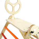 Close up of a Triclimb wooden childrens climbing frame with an arben top deck and steering wheel attachement