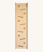 Triclimb wooden Miri slide. A reversible slide that can be used as a ball run, slide and ramp. Showing the different slots for the Triclimb Miri sticks and balls. Features a joint on one end to hook onto a Triclimb pikler climbing frame