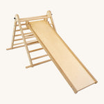 Triclimb wooden folding pikler climbing frame with natural unpainted rungs showing the second side Triclimb Miri slide hooked on a rung.