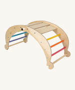 Triclimb wooden folding rocker Archi frame with pastel inspired coloured rungs including pink, orange, yellow, purple blue and green. Features wide wooden slats on top for sitting and attachments on each end to hook onto a Triclimb pikler climbing frame
