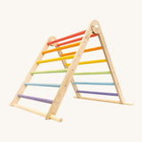 Triclimb folding wooden pikler climbing frame with pastel inspired coloured rungs including purple, blue, green, yellow, orange and pink. Features longer natural coloured rungs on the bottom as a base. 