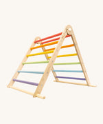 Triclimb folding wooden pikler climbing frame with pastel inspired coloured rungs including purple, blue, green, yellow, orange and pink. Features longer natural coloured rungs on the bottom as a base. 