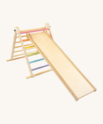 Triclimb wooden folding pikler climbing frame with pastel themed rungs showing the second side Triclimb Miri slide hooked on a rung.
