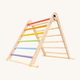 Triclimb folding wooden pikler climbing frame with pastel inspired coloured rungs on one side including purple, blue, green, yellow, orange, pink and natural unpainted rungs on the other side. Features longer natural coloured rungs on the bottom as a base. 