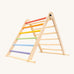 Triclimb folding wooden pikler climbing frame with pastel inspired coloured rungs on one side including purple, blue, green, yellow, orange, pink and natural unpainted rungs on the other side. Features longer natural coloured rungs on the bottom as a base. 
