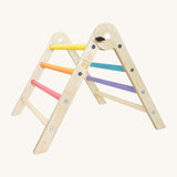Triclimb wooden pastel pwt folding pikler climbing frame. A smaller version of the full size Triclimb pikler climbing frame with pastel themed coloured rungs including pink, orange, yellow, purple, blue and green.
