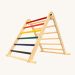riclimb folding wooden pikler climbing frame with rainbow inspired coloured rungs on one side including purple, blue, green, yellow, orange, red and natural unpainted rungs on the other side. Features longer natural coloured rungs on the bottom as a base. 