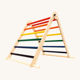 Triclimb folding wooden pikler climbing frame with rainbow inspired coloured rungs including purple, blue, green, yellow, orange and red. Features longer natural coloured rungs on the bottom as a base. 