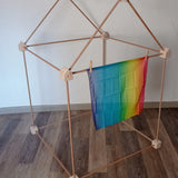 Trigonos wooden big start set made into a tent with a small rainbow cloth hanging on the front