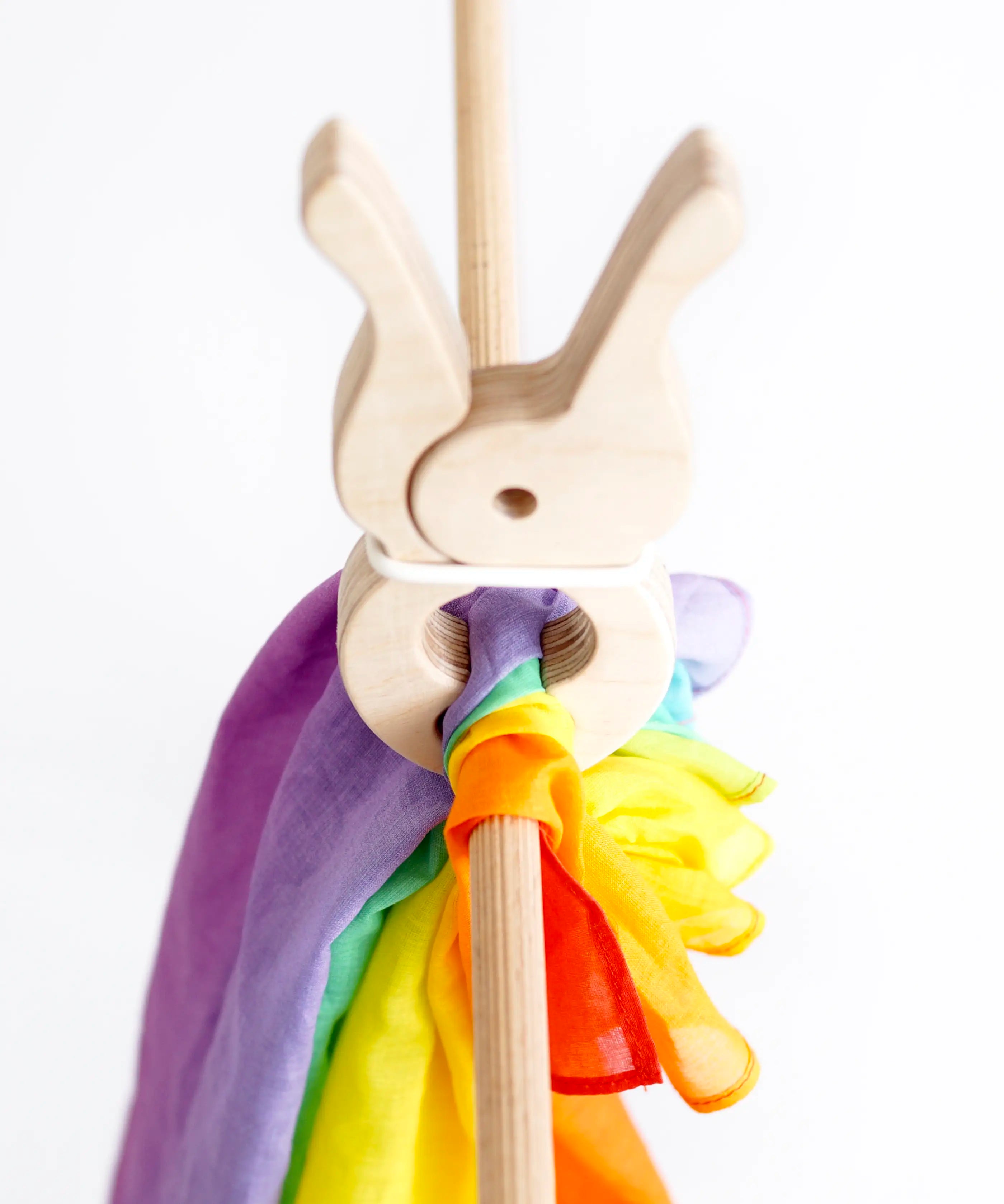 Rainbow cotton cloth from Trigonos big start set clamped by a giant wooden peg on wooden frame pole