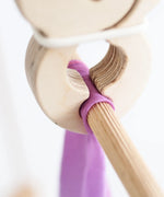 Wooden peg clamping rainbow cloth on a wooden frame pole from the Trigonos big start set