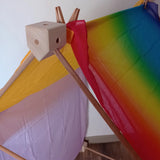 Wooden corner piece holding the tent roof made from the Trigonos big start set with a rainbow cloth on top