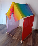 Simple tent build made from the wooden Trigonos big start set showing a rainbow cloth on the roof and coloured cloths on the side