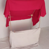 A market stall setup made from the Trigonos wooden big start set showing a red blanket on top of the frame. 