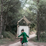 2 children carrying a den made from the Trigonos family wooden construction set