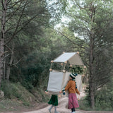 A den made from the Trigonos wooden construction set carried by 2 children in a forestry 