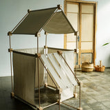 A tent structure made from the Trigonos kernel organic family wooden construction set standing on a concrete surface