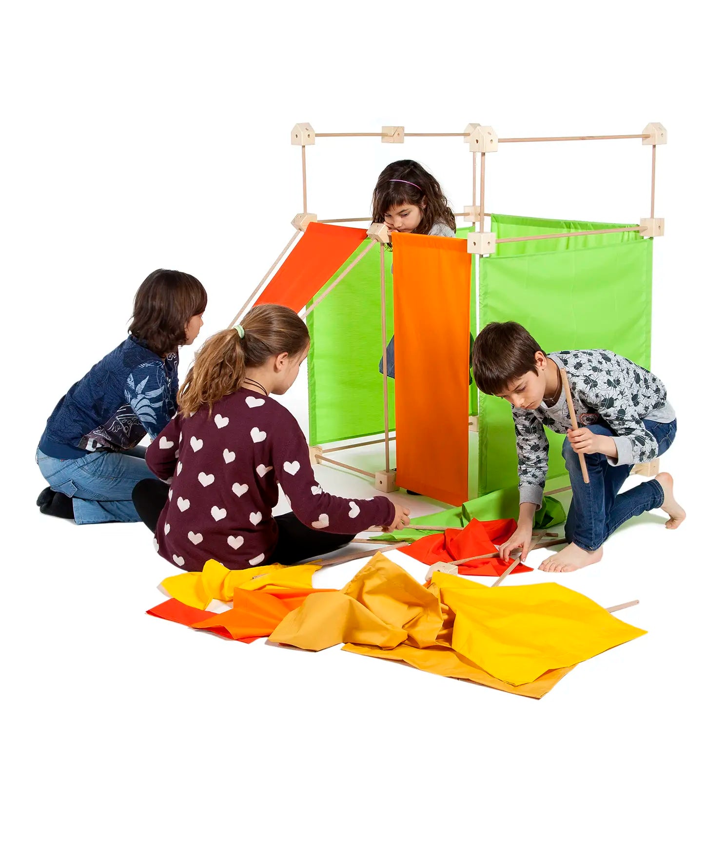 Children building a den made from wooden poles, blocks and coloured sheets from Trigonos maxi construction set