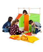 Children building a den made from wooden poles, blocks and coloured sheets from Trigonos maxi construction set