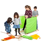Children building a large cube structure made from pieces out of the Trigonos maxi green construction set.
